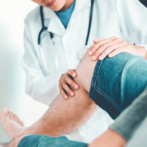 Surgeon Evaluating Patients Knee Mobility